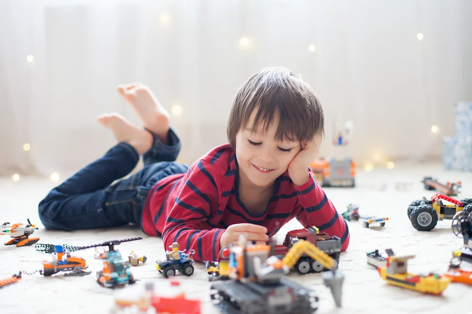 Child playing with new toy, a love language for an autistic child.