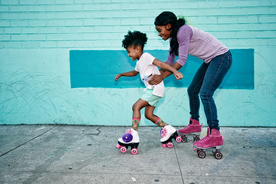 Mom and child roller skating, an activity to help calm after school meltdowns