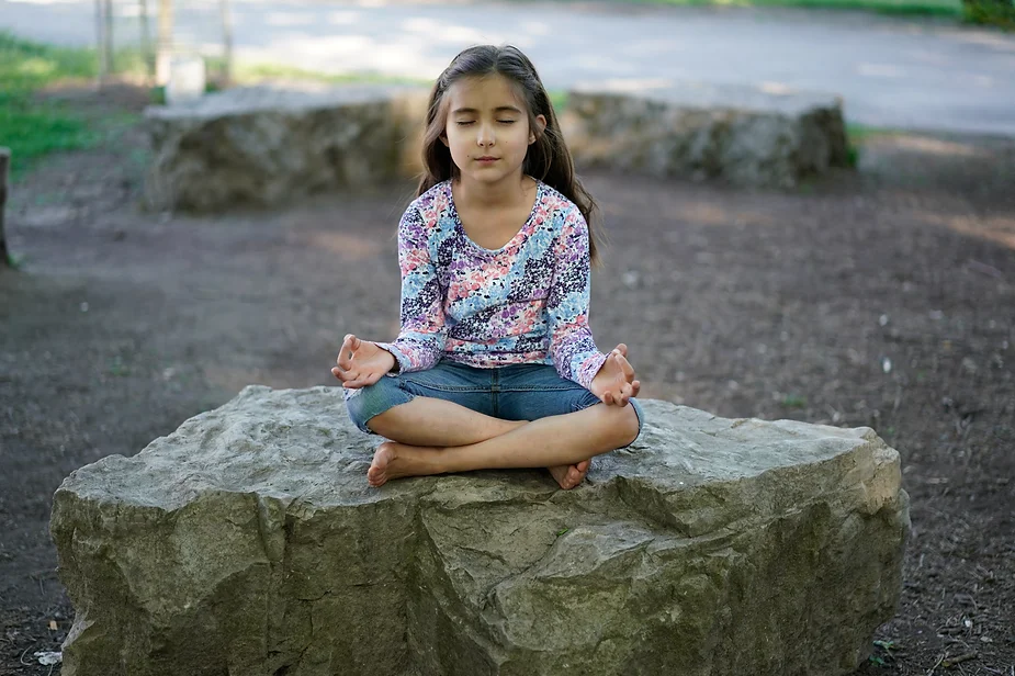 Girl meditating to help calm after school meltdowns