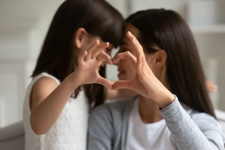 Mom and child making heart hands, showing the Neurodivergent Love Languages