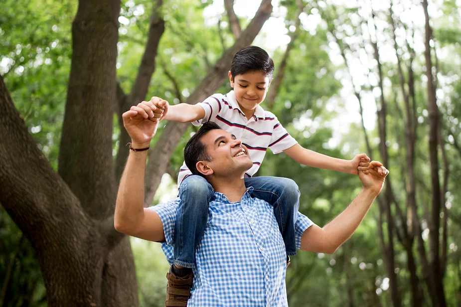 Father giving child a shoulder ride.