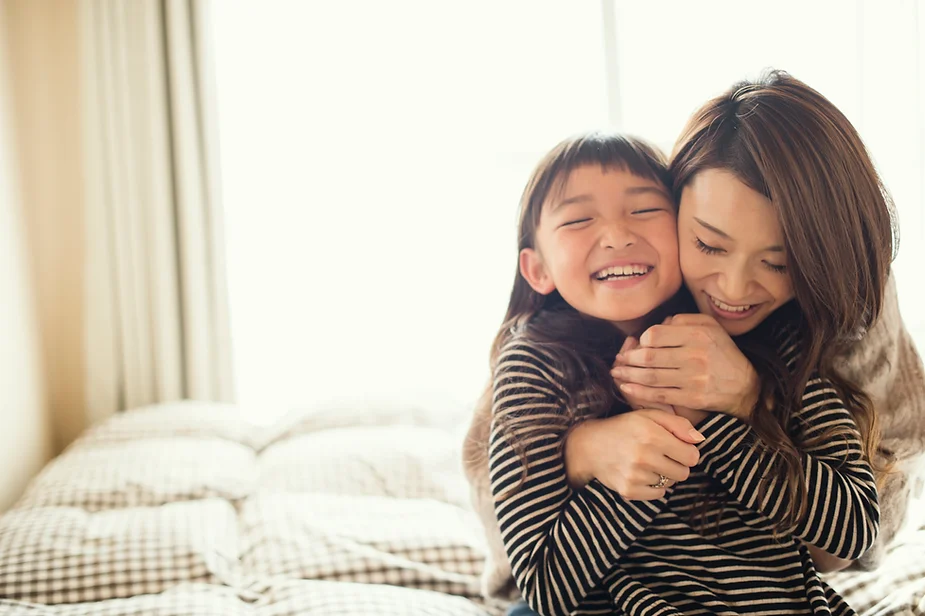 Mom hugging child with deep pressure, one of the the Neurodivergent Love Languages.