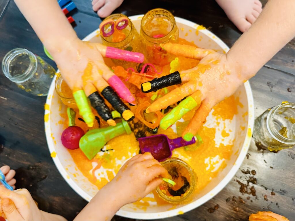 Kid using Monster Fingers to play in the sensory bin.