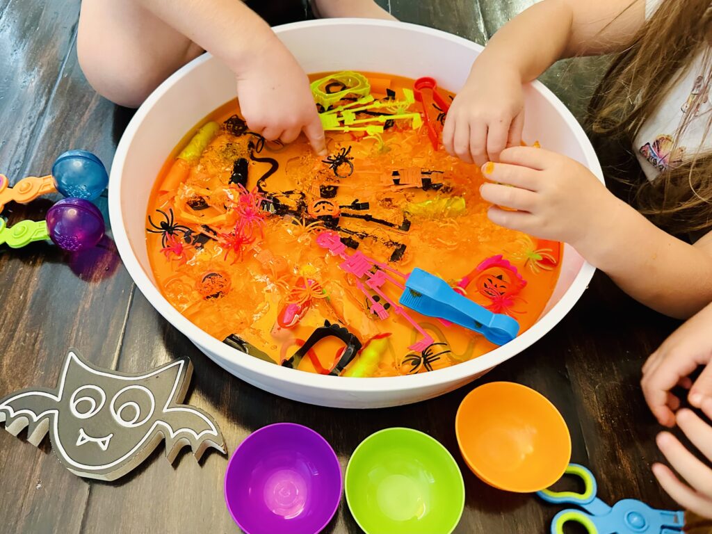 Kids feeling the cold Halloween Jello Sensory Bin